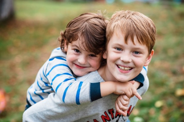 Two happy boys, happy brothers who are smiling happily together