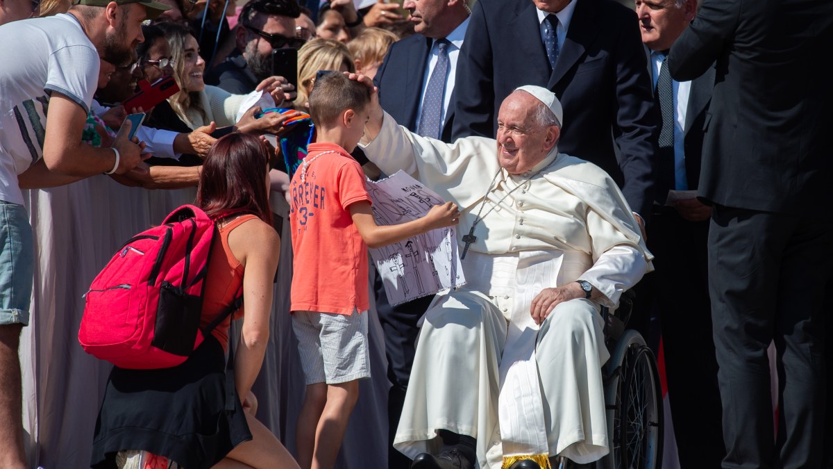 Pope Francis blesses a young pilgrim