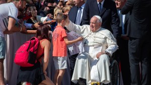 Pope Francis blesses a young pilgrim