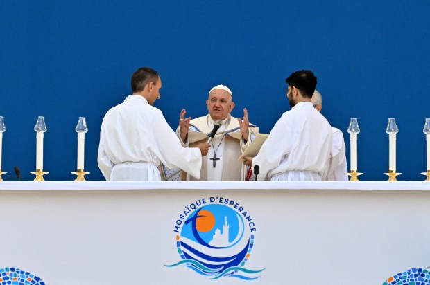 Pope Francis waves as he arrives to celebrate mass at the Velodrome stadium in the southern port city of Marseille