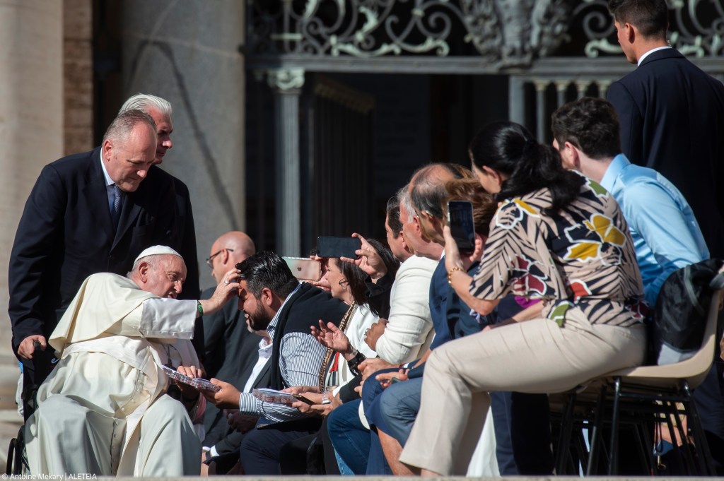 Pope Francis blesses a man at the conclusion of his weekly general audience.