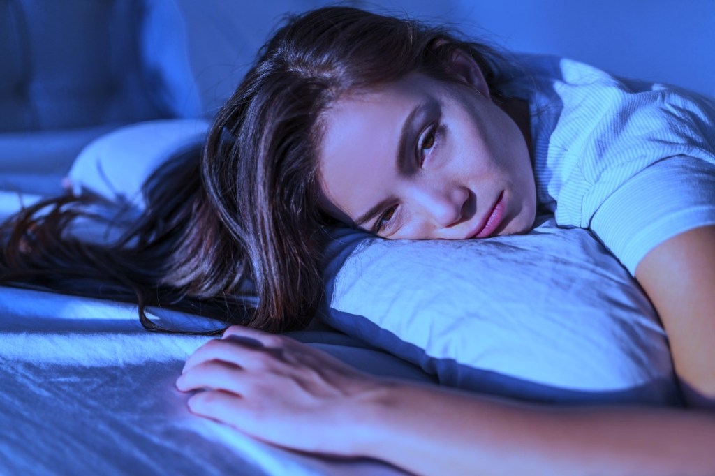Young woman in bed cannot sleep