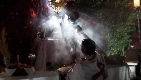 Priest incenses altar