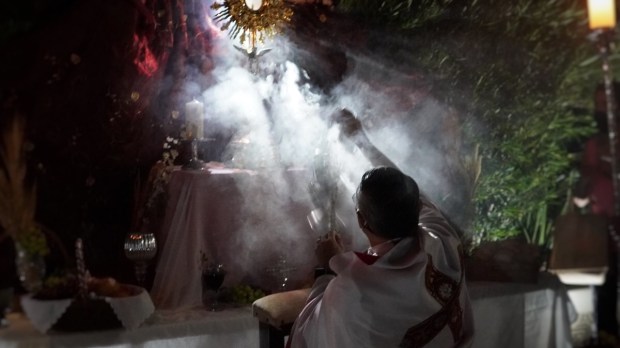 Priest incenses altar