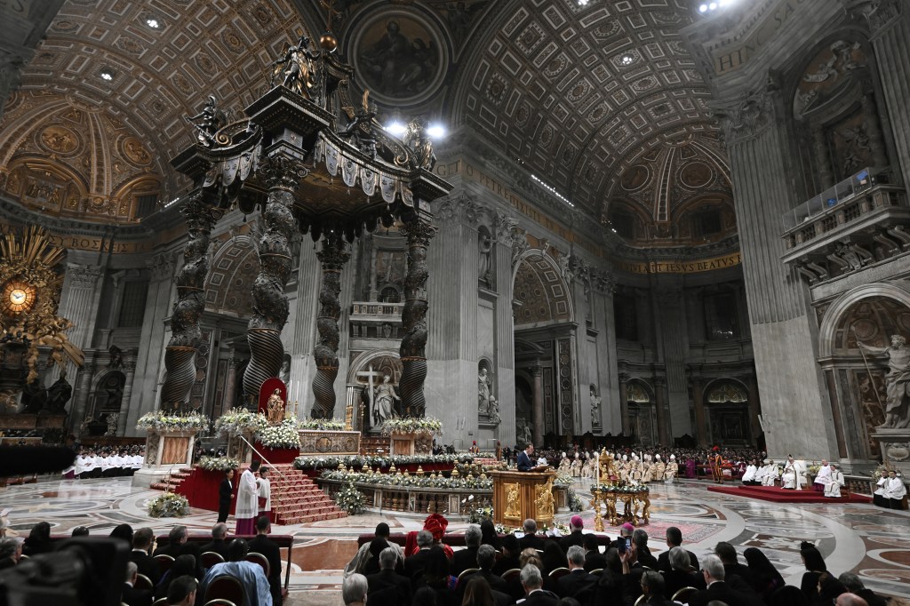 A picture shows a figurine of the baby Jesus during the Christmas Eve mass at St. Peter's Basilica in the Vatican on December 24 2023