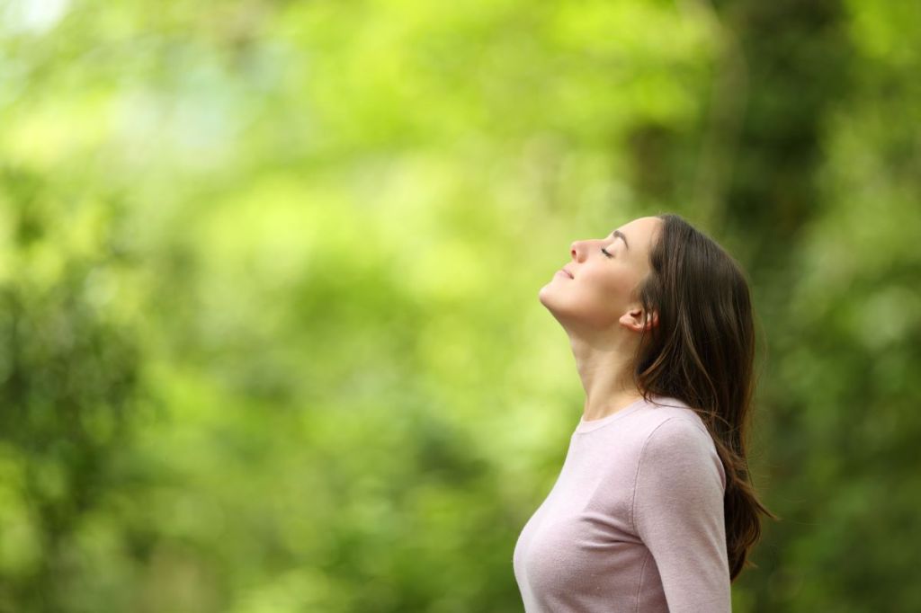 Profile-of-a-relaxed-woman-breathing-fresh-air-in-a-green-forest-shutterstock_1962372739.jpg