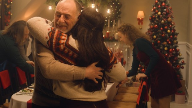 Happy diverse family meeting each other at cozy home for celebrating Christmas or New Year