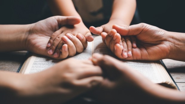 Christian family praying together