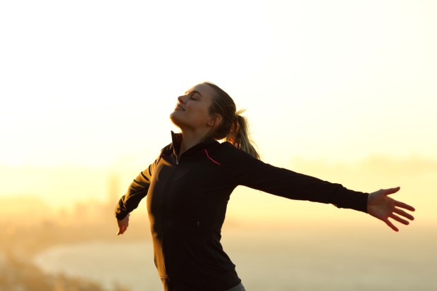 Happy runner breathing fresh air
