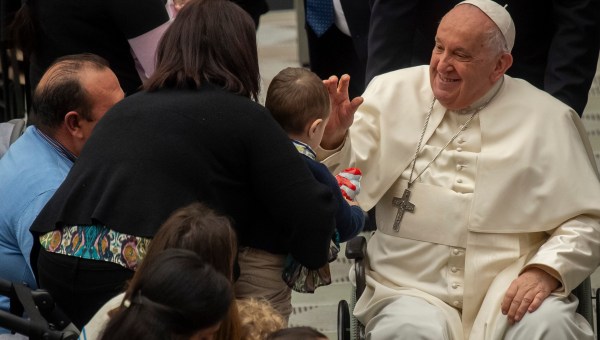Pope Francis as he blesses a baby at the end of his weekly general audience Paul VI hall in the Vatican