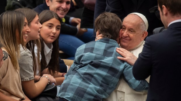 Pope Francis as he blesses a Child at the end of his weekly general audience Paul VI hall in the Vatican
