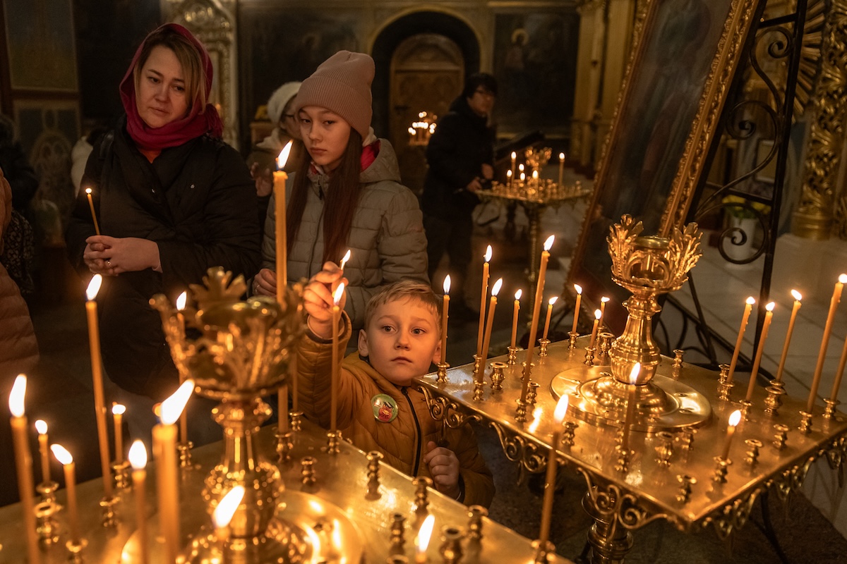 Lighting candles in Ukrainian church