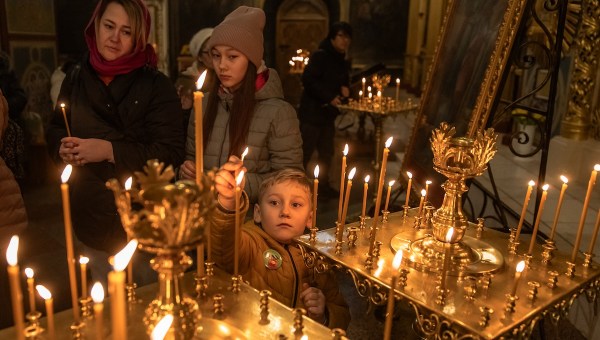 Lighting candles in Ukrainian church
