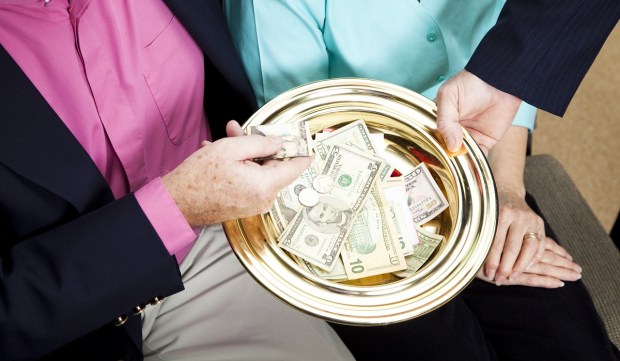 Couple donating to collection plate