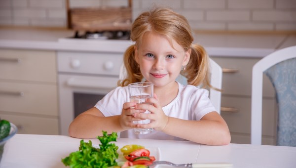 Girl eating veggies drinking water