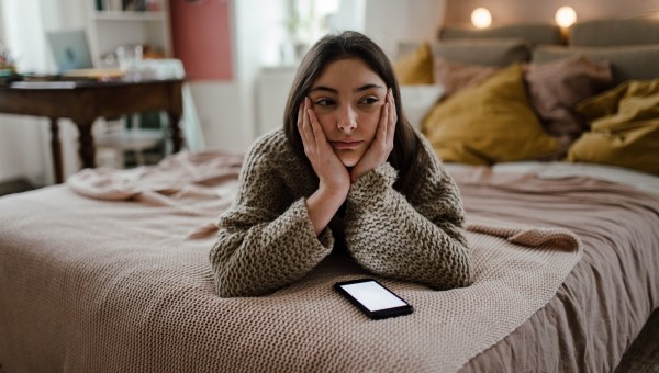 Young teenage girl with smartphone in the room