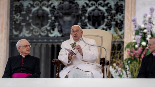 Pope Francis holds a small new Testament from a 23 year old soldier which died in Ukraine