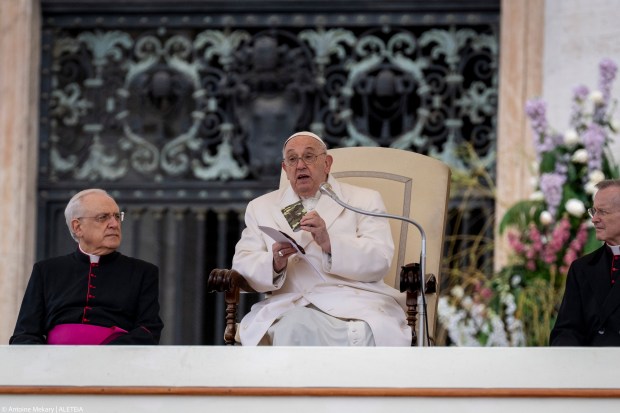 Pope Francis holds a small new Testament from a 23 year old soldier which died in Ukraine