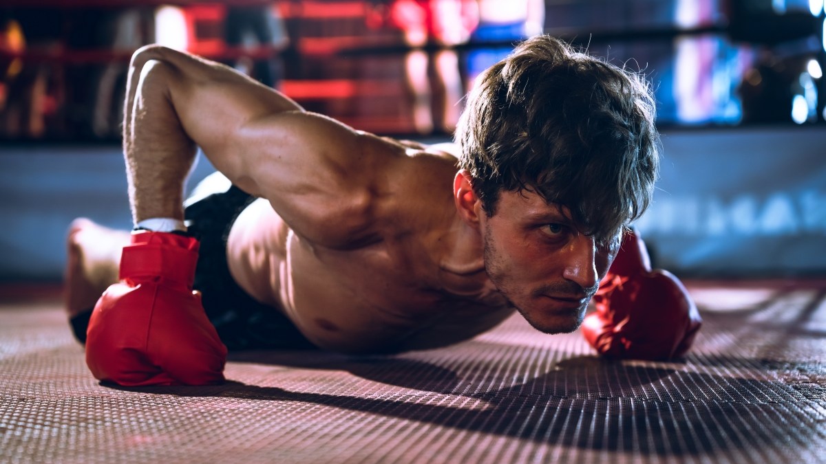 Boxer doing pushups with boxing gloves
