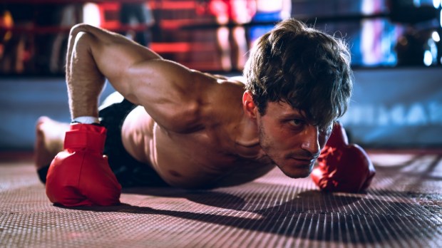 Boxer doing pushups with boxing gloves
