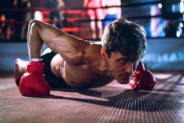 Boxer doing pushups with boxing gloves