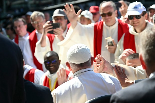 Pope Francis greets people as he arrives to lead a mass at the Bentegodi stadium as part of a visit in Verona, on May 18, 2024