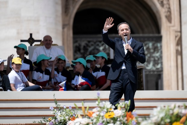 Pope Francis (up) listens to a speech by Italian film director Roberto Benigni during a mass on World Children's Day at St Peter's Basilica in the Vatican on May 26, 2024.
