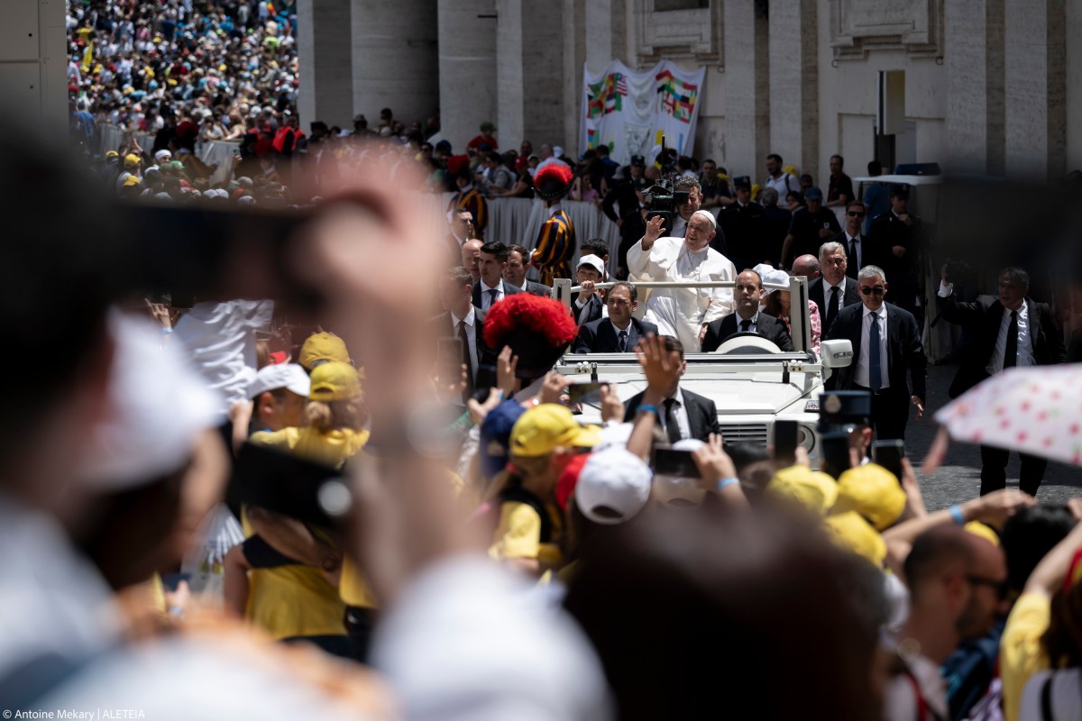 Pope Francis greets the crowd as he leaves after celebrating a mass on World Children's Day at St Peter's Basilica in the Vatican on May 26, 2024.