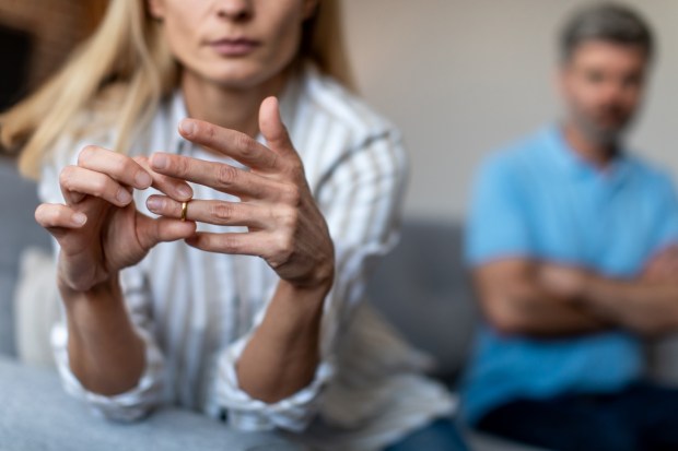 Unhappy middle aged european lady takes off ring