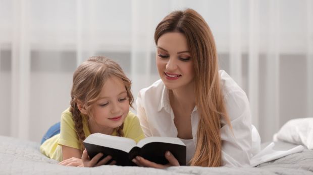 Girl and woman reading the Bible