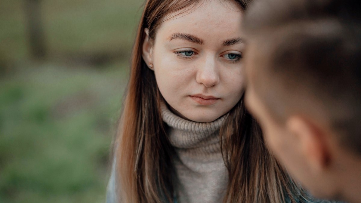 Sad woman having conversation with friend