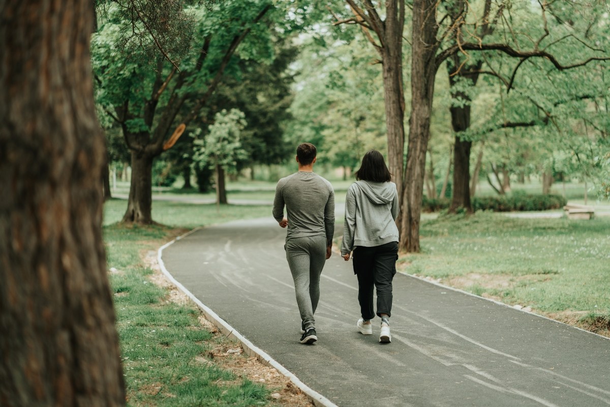 Sport couple walking on the path in the park