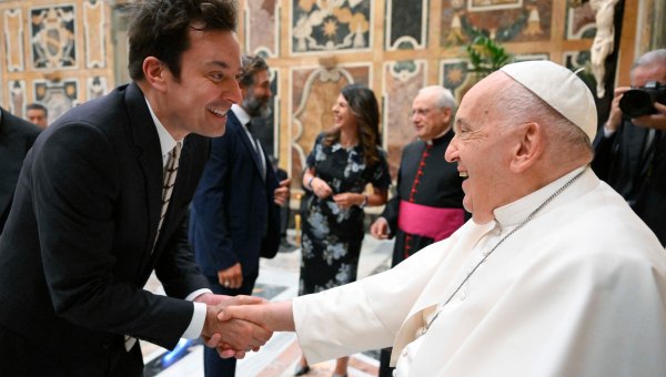 This photo taken and handout on June 14, 2024 by The Vatican Media shows Pope Francis shaking hand with US actor Jimmy Fallon as part of an audience with comedians in The Vatican.