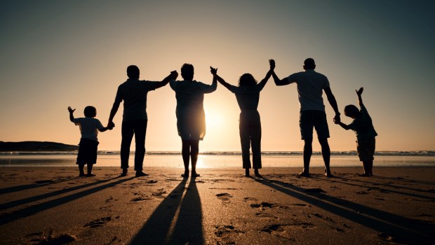 Silhouette, beach and family holding hands in sunset