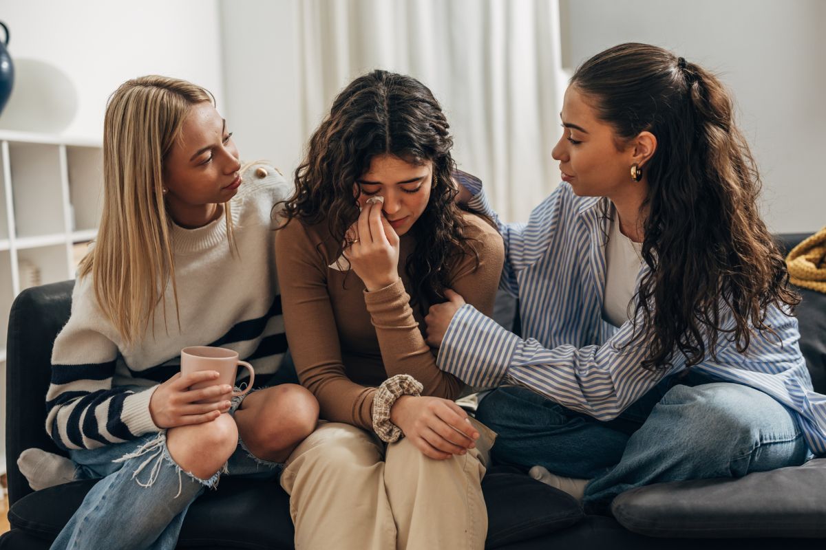 Women comforting their sad friend