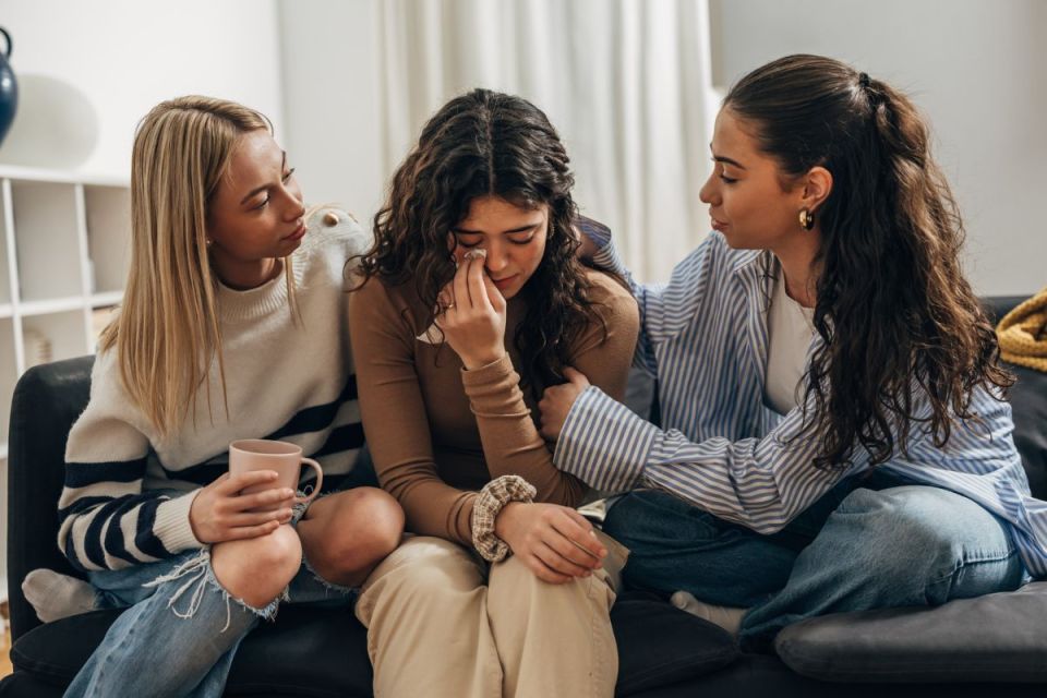 Women comforting their sad friend