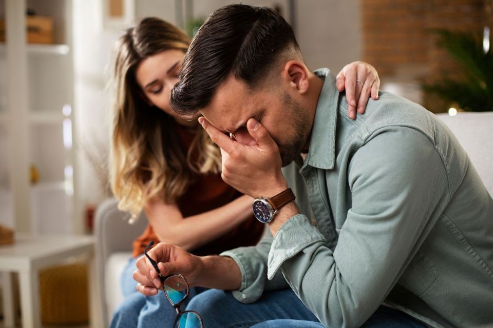 Man being comforted by his friend
