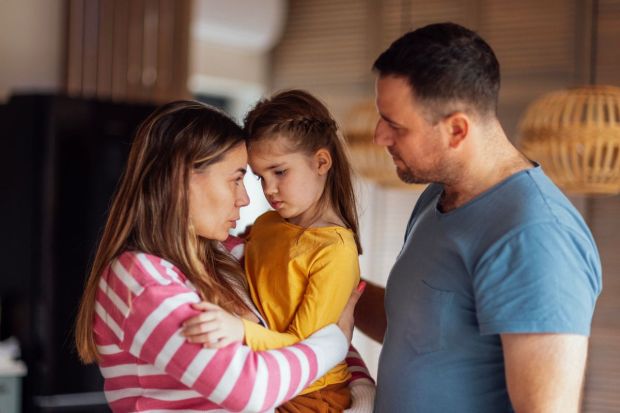 parents comforting their daughter