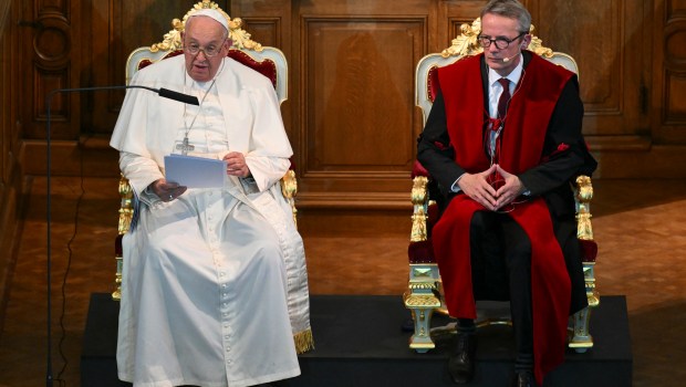 Pope Francis (L) speaks as he attends a meeting with KU Leuven rector Luc Sels at the Katholieke Universiteit Leuven in Leuven, on September 27, 2024, during his visit to Belgium