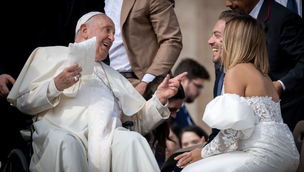 Pope Francis jokes with a newlywed couple