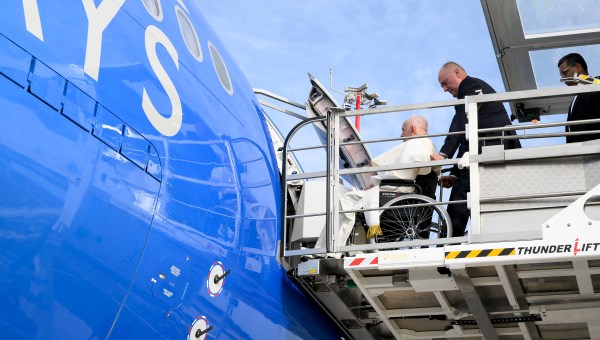 Pope Francis seated on a wheelchair boards his plane heading to Indonesia on Septemper 2, 2024 at Rome's Fiumicino airport