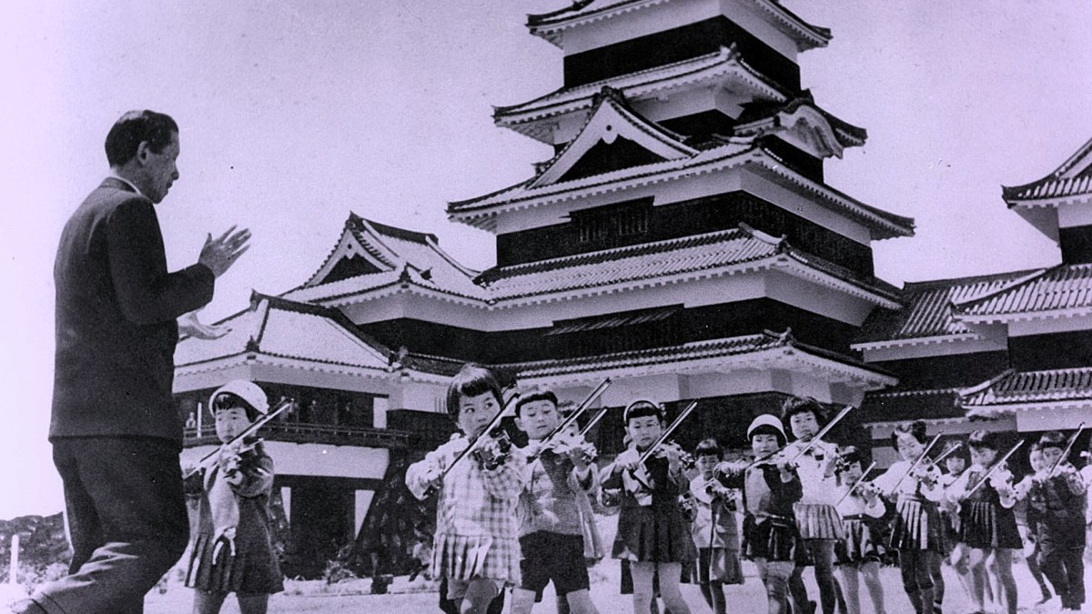 Shinichi Suzuki gives a music lesson outside Matsumoto Castle in Japan