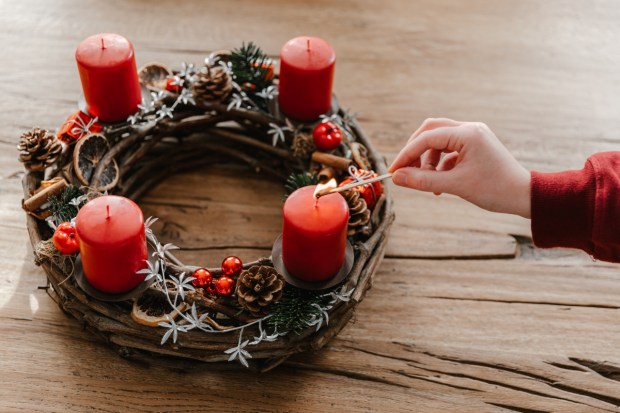 First candle on advent wreath made with branches
