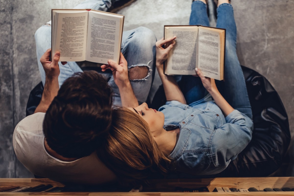 COUPLE READING NEXT TO EACH OTHER