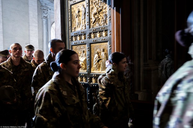 Members of the military walk through St. Peter Basilica's holy door, on the occasion of Italian Armed Forces jubilee, at the Vatican, Saturday, Feb. 8, 2025.