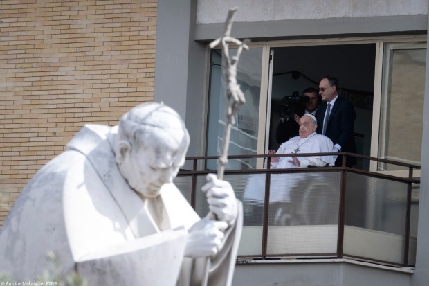 Pope Francis waves from a window of the Gemelli hospital before to be discharge after a five weeks hospitalization for pneumonia, in Rome on March 23, 2025