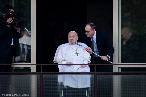 Pope Francis waves from a window of the Gemelli hospital before to be discharge after a five weeks hospitalization for pneumonia, in Rome on March 23, 2025.