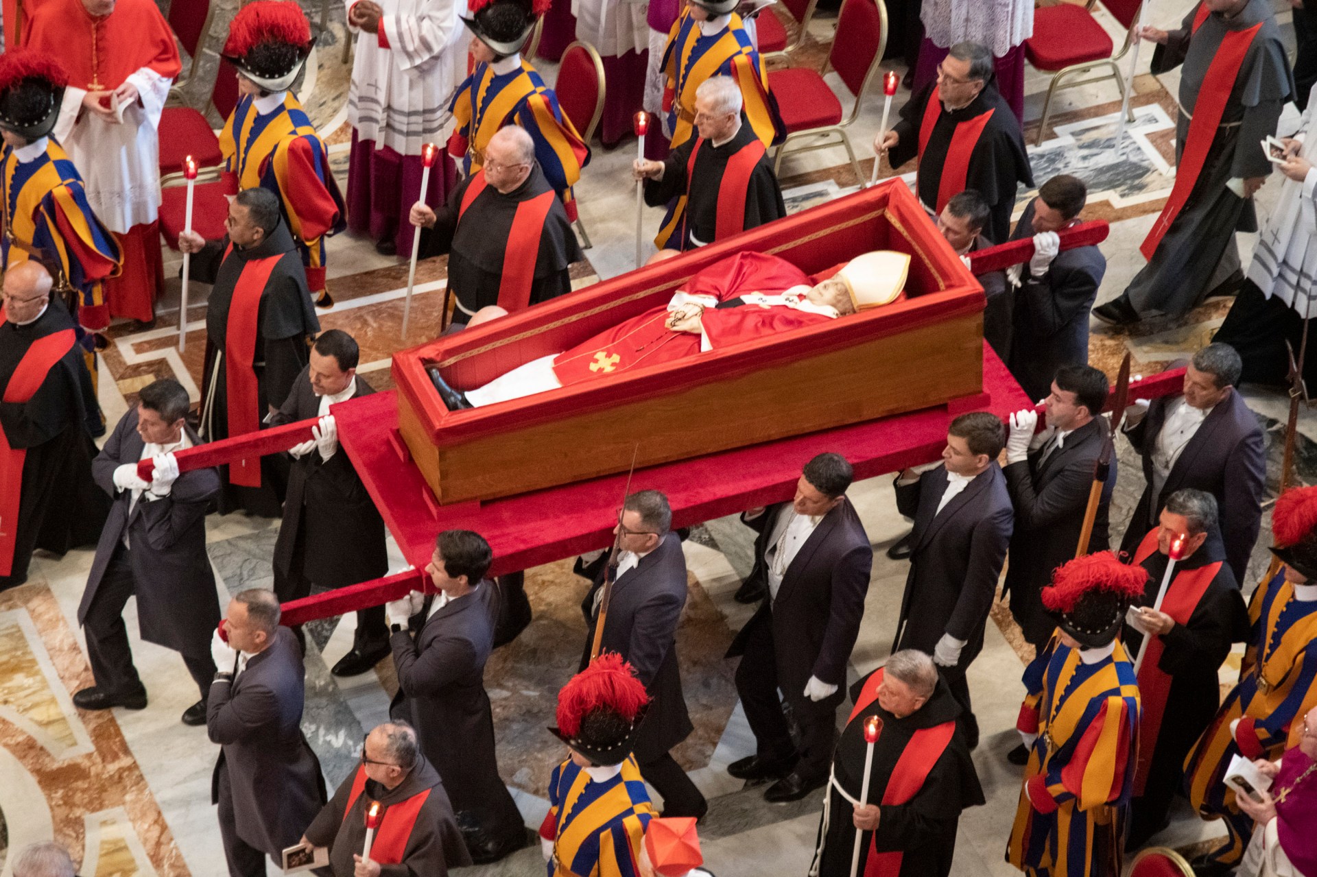 Pallbearers carry the coffin of the late Pope Francis inside St Peter's Basilica as it is transported in a procession from the chapel of Santa Marta to St Peter's Basilica, following the Pope's death, in the Vatican on April 23, 2025.