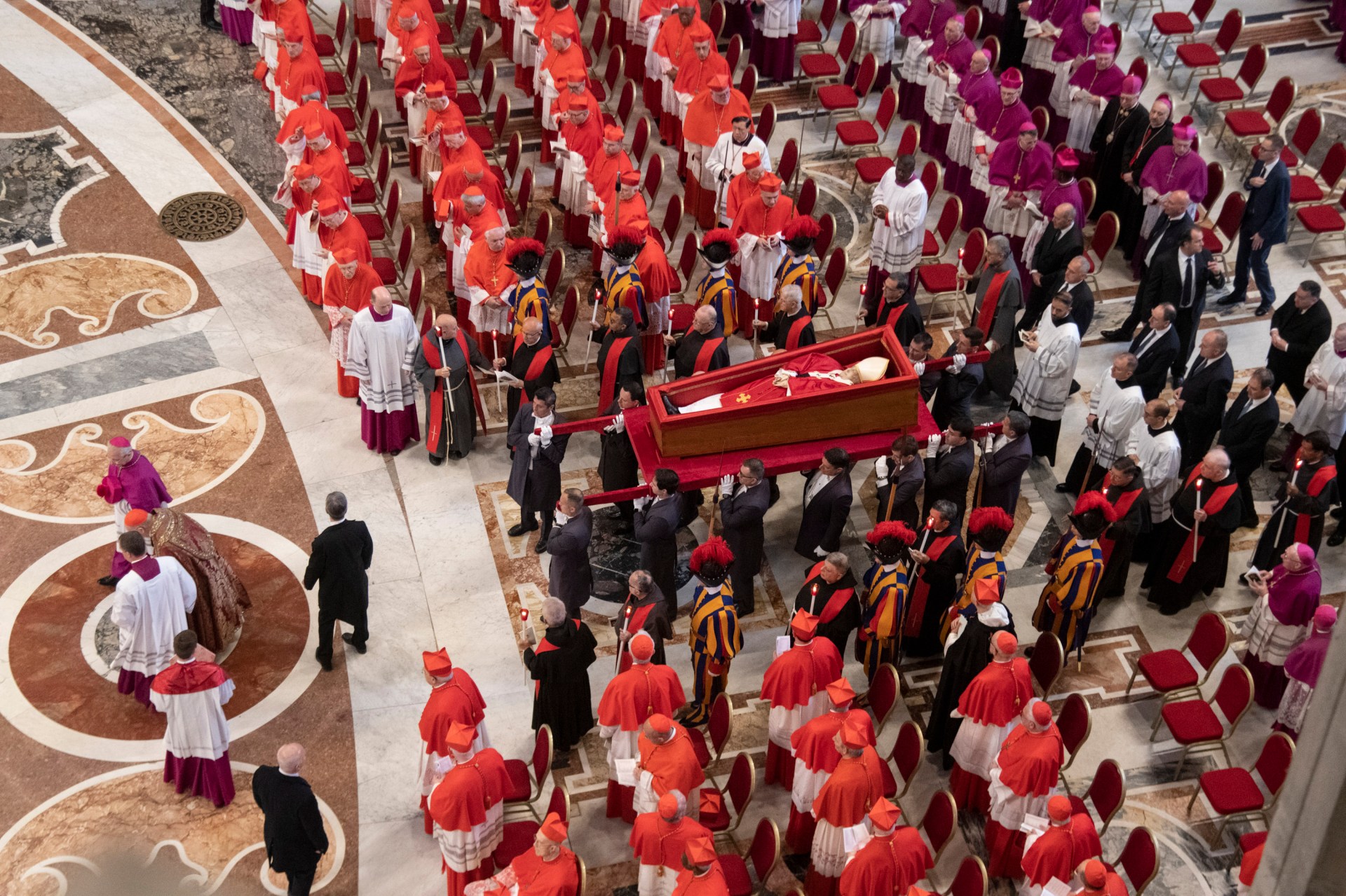 Pallbearers carry the coffin of the late Pope Francis inside St Peter's Basilica as it is transported in a procession from the chapel of Santa Marta to St Peter's Basilica, following the Pope's death, in the Vatican on April 23, 2025.