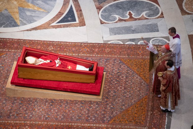 Pallbearers carry the coffin of the late Pope Francis inside St Peter's Basilica as it is transported in a procession from the chapel of Santa Marta to St Peter's Basilica, following the Pope's death, in the Vatican on April 23, 2025.